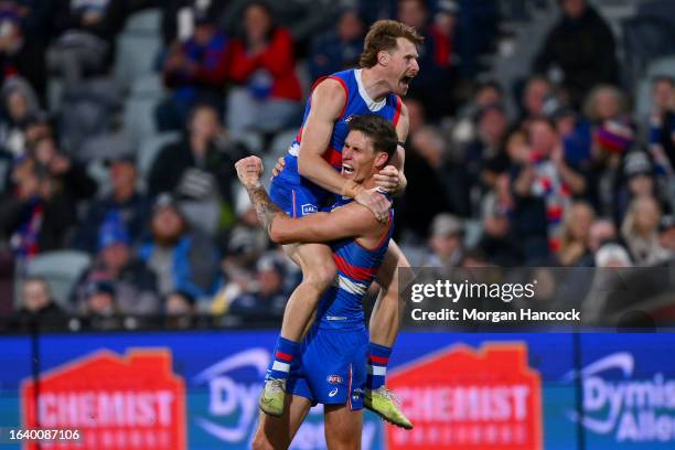 Oskar Baker and Rory Lobb of the Bulldogs celebrate a goal during the round 24 AFL match between Geelong Cats and Western Bulldogs at GMHBA Stadium,...