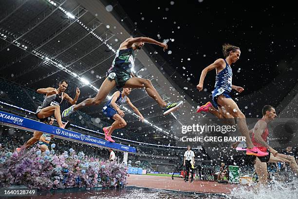 Runners compete in the men's 3000m steeplechase final during the IAAF Diamond League athletics meeting at Egret Stadium in Xiamen, in China's eastern...