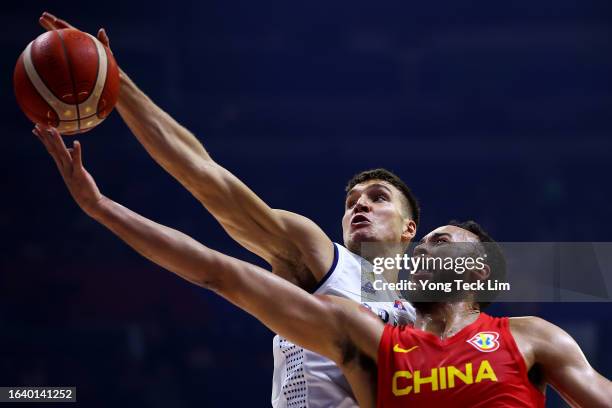 Bogdan Bogdanovic of Serbia blocks a shot by Kyle Anderson of China in the second quarter during the FIBA Basketball World Cup Group B game at...