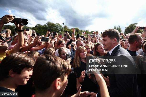 France's scrum-half Antoine Dupont meets fans as he attends a welcoming ceremony for the team at the Parc du Bois-Preau in Rueil-Malamaison, near...