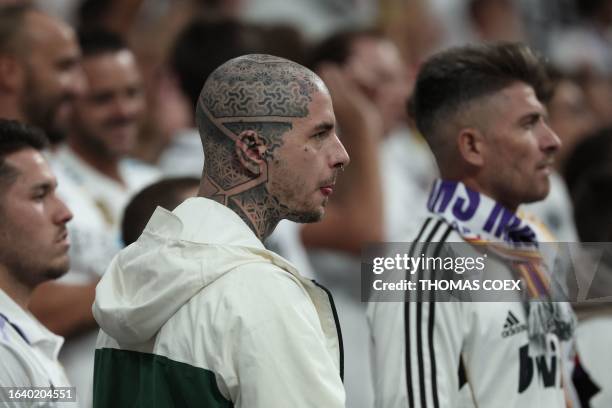 Supporters react at the end of the Spanish Liga football match between Real Madrid CF and Getafe CF at the Santiago Bernabeu stadium in Madrid on...