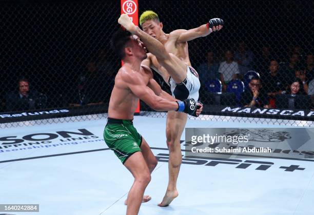Rinya Nakamura of Japan kicks Fernie Garcia in a bantamweight bout during the UFC Fight Night event at Singapore Indoor Stadium on August 26, 2023 in...