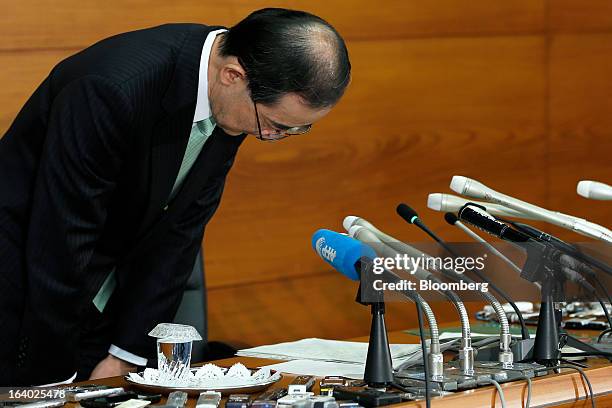 Masaaki Shirakawa, outgoing governor of the Bank of Japan, bows as he leaves a news conference at the central bank's headquarters in Tokyo, Japan, on...