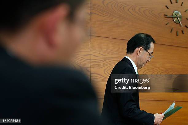 Masaaki Shirakawa, outgoing governor of the Bank of Japan, leaves a news conference at the central bank's headquarters in Tokyo, Japan, on Tuesday,...