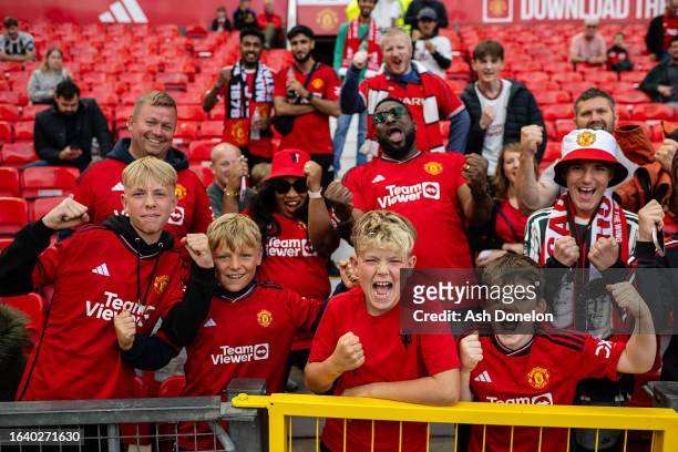 Manchester United fans watch from the stands ahead of the Premier League match between Manchester United and Nottingham Forest at Old Trafford on...