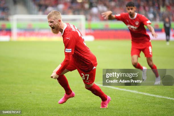 Jan-Niklas Beste of 1.FC Heidenheim celebrates after scoring the team's first goal during the Bundesliga match between 1. FC Heidenheim 1846 and TSG...