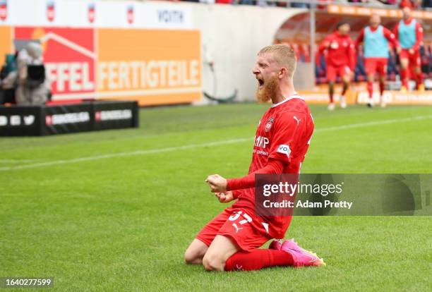 Jan-Niklas Beste of 1.FC Heidenheim celebrates after scoring the team's first goal during the Bundesliga match between 1. FC Heidenheim 1846 and TSG...