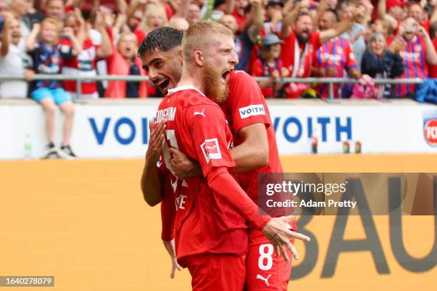 Jan-Niklas Beste of 1.FC Heidenheim celebrates with Eren Dinkci of 1.FC Heidenheim after scoring the team's first goal during the Bundesliga match...