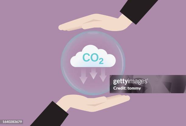 hand with co2 cloud icon for net zero emission concept - carbon footprint reduction stock illustrations