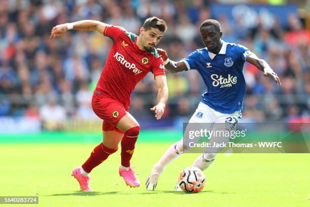 Pedro Neto of Wolverhampton Wanderers runs with the ball whilst under pressure from Idrissa Gueye of Everton during the Premier League match between...