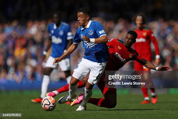 Lewis Dobbin of Everton is fouled by Nelson Semedo of Wolverhampton Wanderers during the Premier League match between Everton FC and Wolverhampton...