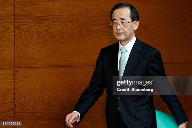 Masaaki Shirakawa, outgoing governor of the Bank of Japan, arrives for a news conference at the central bank's headquarters in Tokyo, Japan, on...