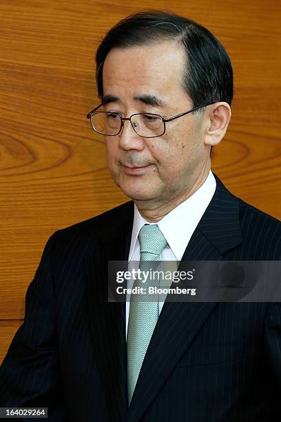 Masaaki Shirakawa, outgoing governor of the Bank of Japan, arrives for a news conference at the central bank's headquarters in Tokyo, Japan, on...
