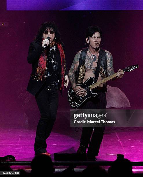 Singer Paul Shortino and musician Tracii Guns perform on stage during the Raiding of the Rock Vault VIP opening and red carpet at the LVH Hotel &...