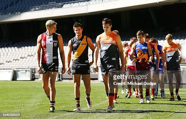 The AFL team captains walk onto the field during the AFL Captains media Day at Etihad Stadium on March 19, 2013 in Melbourne, Australia.