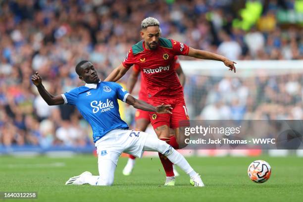 Idrissa Gueye of Everton tackles Matheus Cunha of Wolverhampton Wanderers during the Premier League match between Everton FC and Wolverhampton...