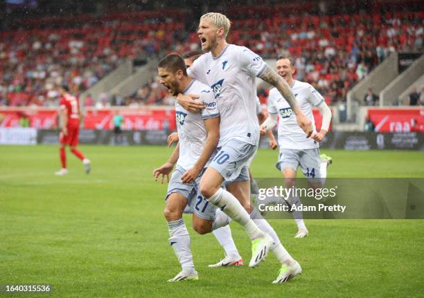 Andrej Kramaric of TSG 1899 Hoffenheim celebrates with Wout Weghorst of TSG 1899 Hoffenheim after scoring the team's third goal from the penalty-spot...