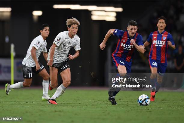 Yuya Osako of Vissel Kobe and Henrique Trevisan of FC Tokyo compete for the ball during the J.LEAGUE Meiji Yasuda J1 25th Sec. Match between...