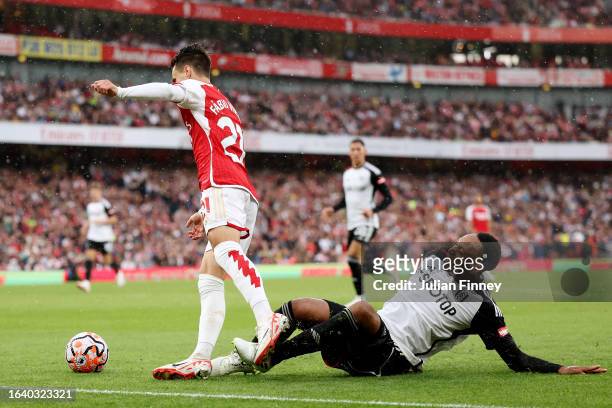 Fabio Vieira of Arsenal is fouled by Kenny Tete of Fulham leading to a penalty being awarded during the Premier League match between Arsenal FC and...