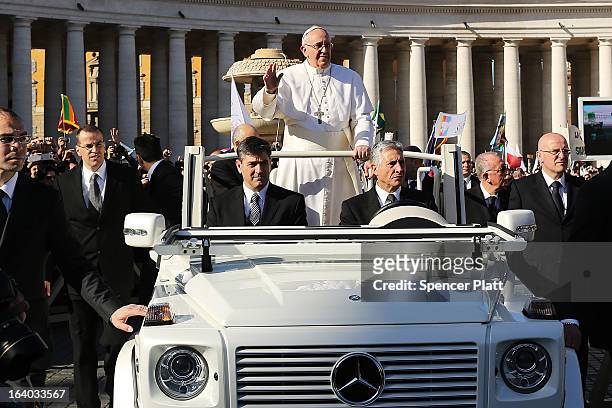 Pope Francis drives through the crowds during the Inauguration Mass for the Pope in St Peter's Square on March 19, 2013 in Vatican City, Vatican. The...