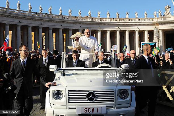 Pope Francis drives through the crowds during the Inauguration Mass for the Pope in St Peter's Square on March 19, 2013 in Vatican City, Vatican. The...