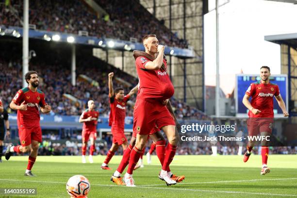 Sasa Kalajdzic of Wolverhampton Wanderers celebrates after scoring the team's first goal during the Premier League match between Everton FC and...