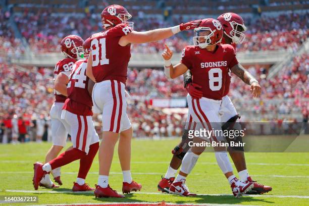 Tight end Austin Stogner congratulates quarterback Dillon Gabriel of the Oklahoma Sooners on his 5-yard touchdown run against the Arkansas State Red...