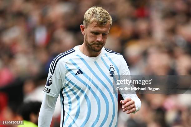 Joe Worrall of Nottingham Forest looks dejected as he leaves the pitch having received a red card for a tackle on Bruno Fernandes of Manchester...