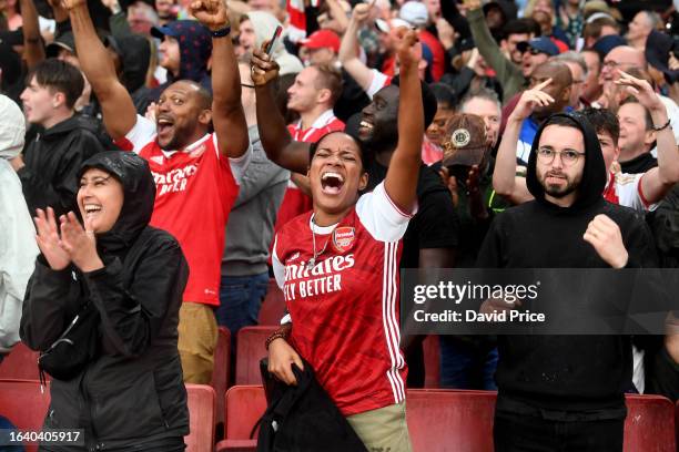 Arsenal fans celebrate during the Premier League match between Arsenal FC and Fulham FC at Emirates Stadium on August 26, 2023 in London, England.