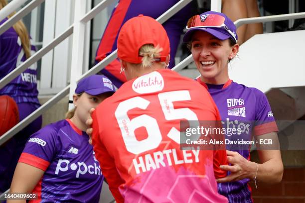 Kate Cross of Northern Superchargers shakes hands with Alex Hartley of Welsh Fire after the match is abandoned following a Storm and Lightning,...