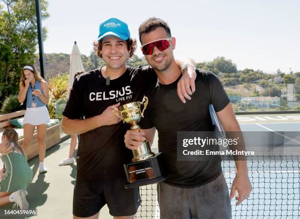 David Dobrik and Taylor Lautner, winners of the CELSIUS pickleball tournament at David Dobrik’s home, pose with the award on August 25, 2023 in...