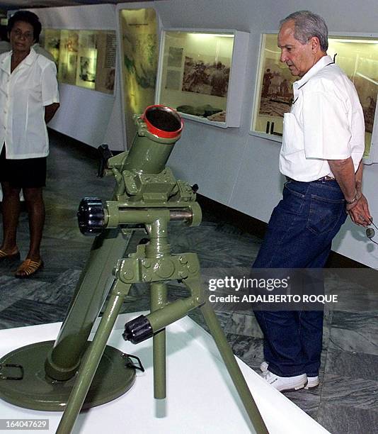 Alfredo Duran of Miami, Florida, looks at a military piece in a museum 24 March 2001 in Cuba. Forty years ago Duran participated as a member of...