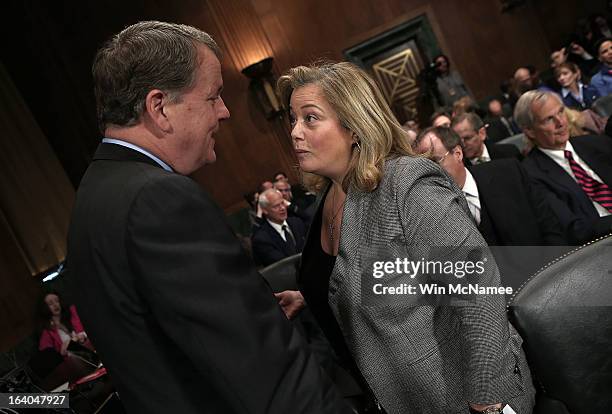 Douglas Parker , chairman and CEO of the US Airways Group speaks with lobbyist Hillary Rosen before a hearing of the Senate Judiciary Committee on...