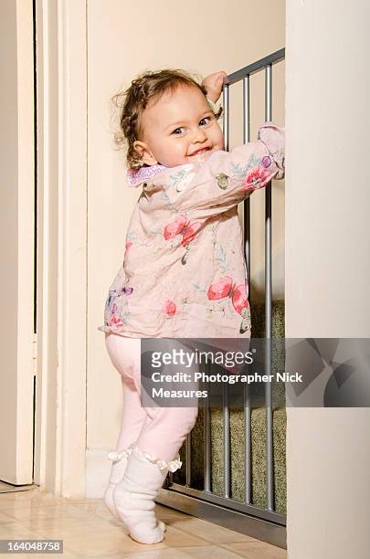 baby girl - baby gate stock pictures, royalty-free photos & images