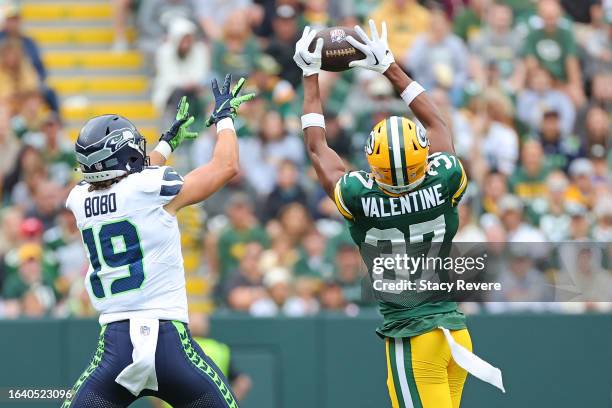 Carrington Valentine of the Green Bay Packers defends a pass intended for Jake Bobo of the Seattle Seahawks during the first quarter of a preseason...