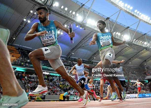 Amoj Jacob of Team India hands the baton to Muhammed Ajmal Variyathodi of Team India in the Men's 4x400m Relay Heats during day eight of the World...