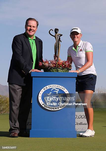 Rick Ryan, Director of Marketing for RR Donnelley and Stacy Lewis pose with the trophy after winning the the RR Donnelley LPGA Founders Cup and...