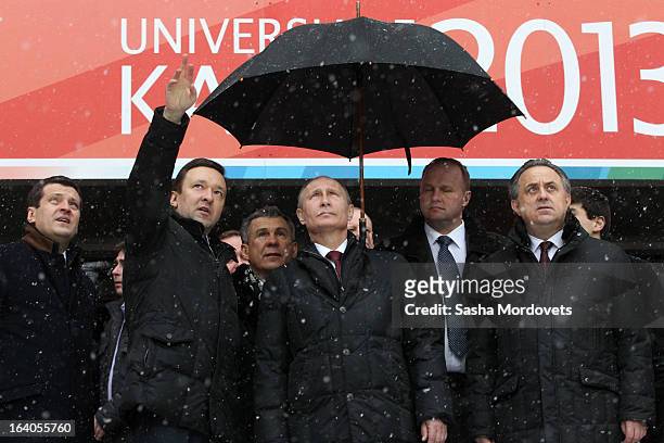 Russian President Vladimir Putin , Minister of Sport Vitaly Mutko and Tatar President Rustam Minnikhanov look on during a tour of the venues for the...