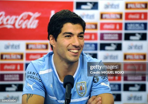 Uruguay's footballer Luis Suarez smiles during a press conference following a training session on March 19 at the "Uruguay Celeste" Complex in...