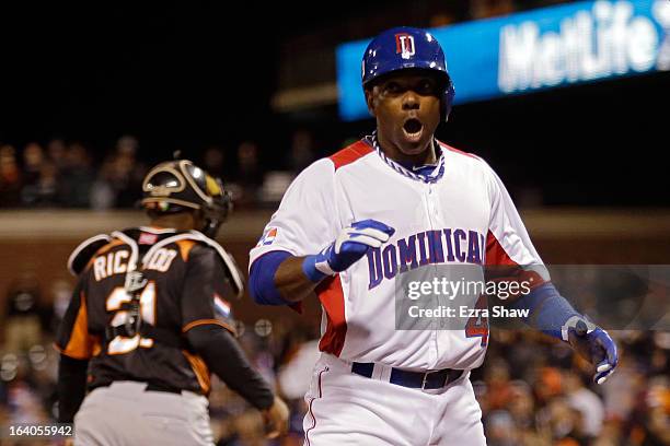 Miguel Tejada of the Dominican Republic celebrates after scoring in the fifth inning against the Netherlands during the semifinal of the World...