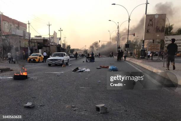 Iraqi protesters block a road following protests in the multi-ethnic Iraqi city of Kirkuk on September 2, 2023. At least one civilian was killed and...