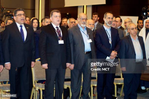 Syrian National Coalition members Ghassan Hitto, Salim Muslit, Hiathem Maleh, Moaz Khatib and Abdel Basit Saida sing the Syrian national anthem...