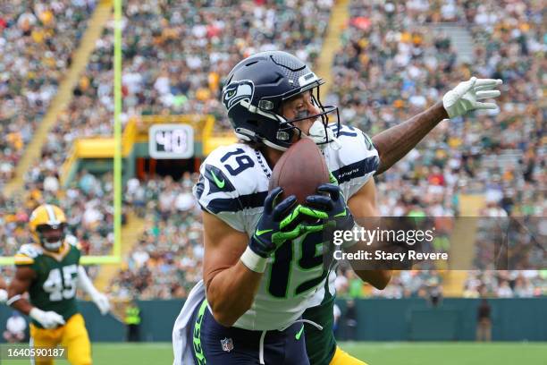 Jake Bobo of the Seattle Seahawks catches a pass for a touchdown in front of Innis Gaines of the Green Bay Packers during the second quarter of a...