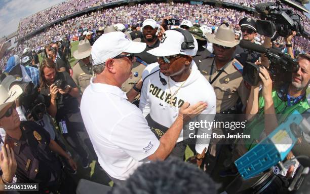 Head coach Sonny Dykes of the TCU Horned Frogs and head coach Deion Sanders of the Colorado Buffaloes meet on the field following the game at Amon G....