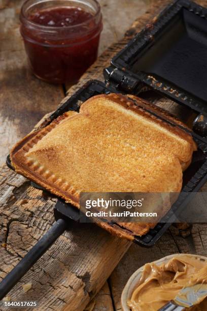 campfire peanut butter and jam sandwich - peanut butter and jelly sandwich stock pictures, royalty-free photos & images
