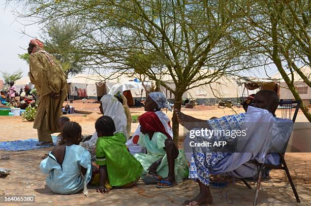 People displaced by the conflict sit in the shade at Sevare, in the centre of Mali, some 600km north-east of Bamako on March 18 where almost 600 live...