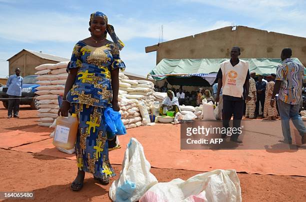 People displaced by the conflict receive rations at Sevare, in the centre of Mali, some 600km north-east of Bamako on March 18 where almost 600 live...