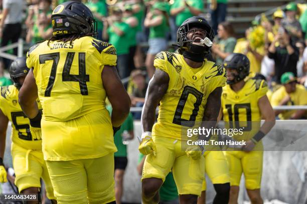 Running back Bucky Irving of the Oregon Ducks celebrates a touchdown in the first half against the Portland State Vikings at Autzen Stadium on...