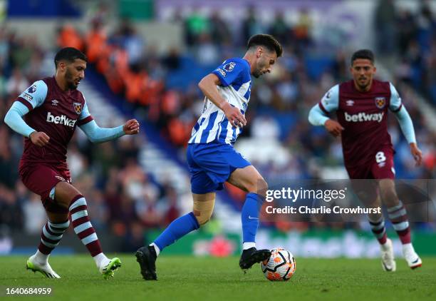 Adam Lallana of Brighton & Hove Albion looks to hold off West Ham's Said Benrahma during the Premier League match between Brighton & Hove Albion and...