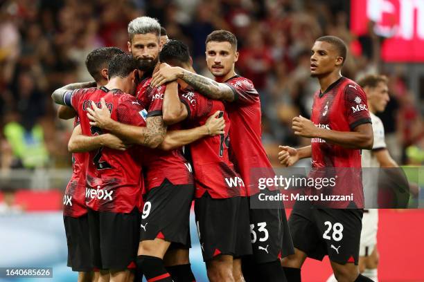 Olivier Giroud of AC Milan celebrates with teammates after scoring the team's second goal from a penalty kick during the Serie A TIM match between AC...